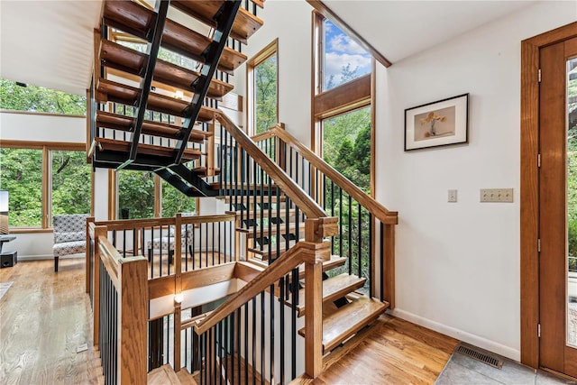 stairway with hardwood / wood-style flooring