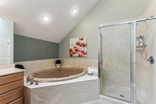 bathroom featuring independent shower and bath, vanity, and vaulted ceiling