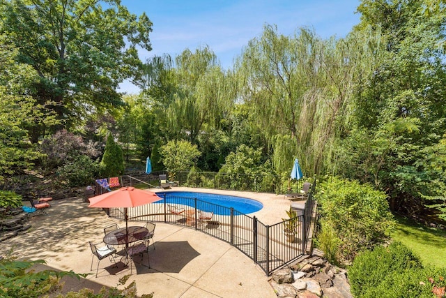 view of pool with an outdoor fire pit, fence, a fenced in pool, and a patio