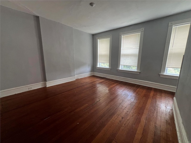 unfurnished room with wood-type flooring