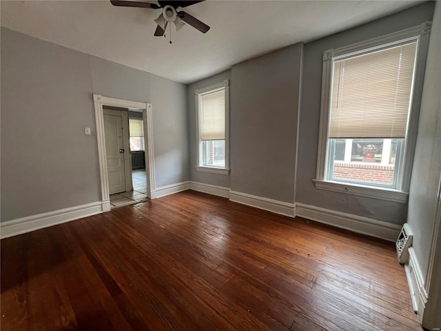 spare room featuring ceiling fan, a wealth of natural light, and hardwood / wood-style flooring