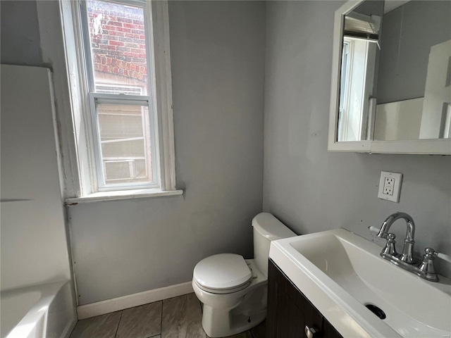 bathroom with vanity, tile patterned flooring, and toilet