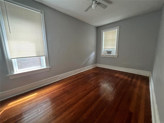 spare room with ceiling fan, wood-type flooring, plenty of natural light, and cooling unit