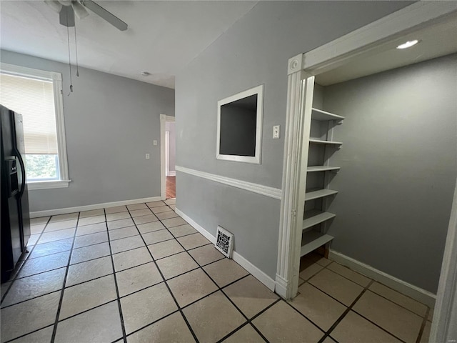 interior space with ceiling fan and tile patterned floors