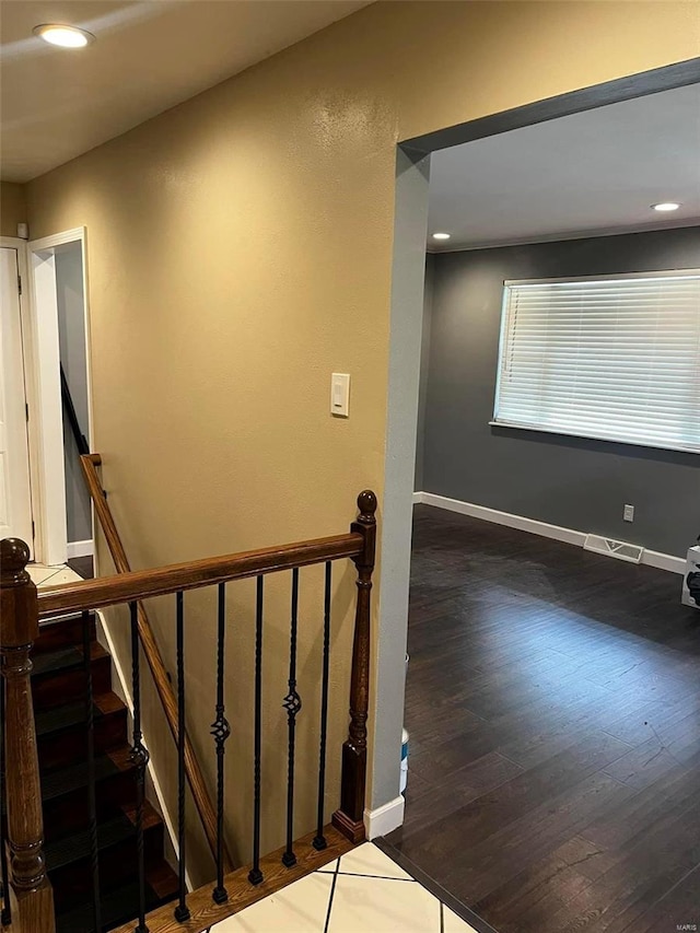 staircase with hardwood / wood-style flooring