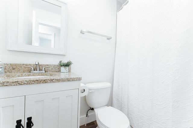 bathroom featuring vanity, toilet, and a shower with curtain