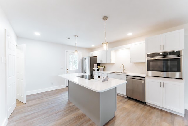 kitchen with white cabinetry, sink, and stainless steel appliances