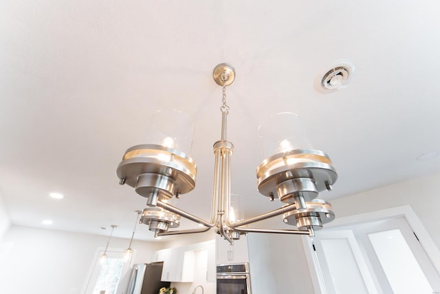 room details featuring appliances with stainless steel finishes and white cabinetry