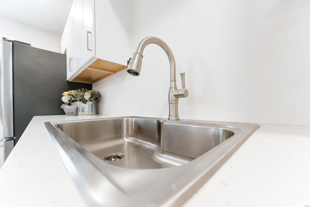 interior details with white cabinets and sink