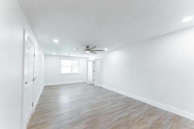 empty room featuring light wood-type flooring and ceiling fan