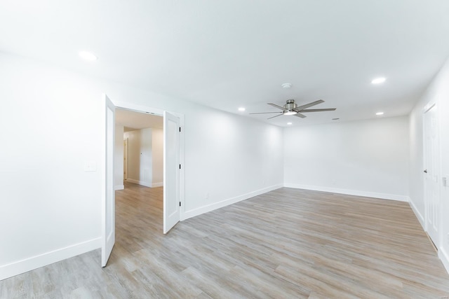 spare room featuring ceiling fan and light hardwood / wood-style flooring