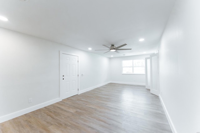 spare room with light wood-type flooring and ceiling fan