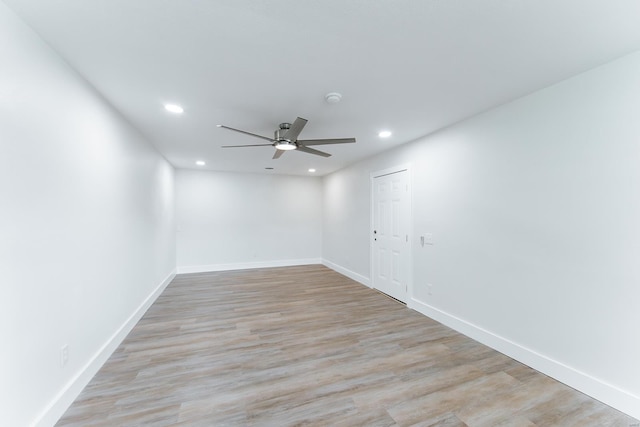 empty room featuring light wood-type flooring and ceiling fan