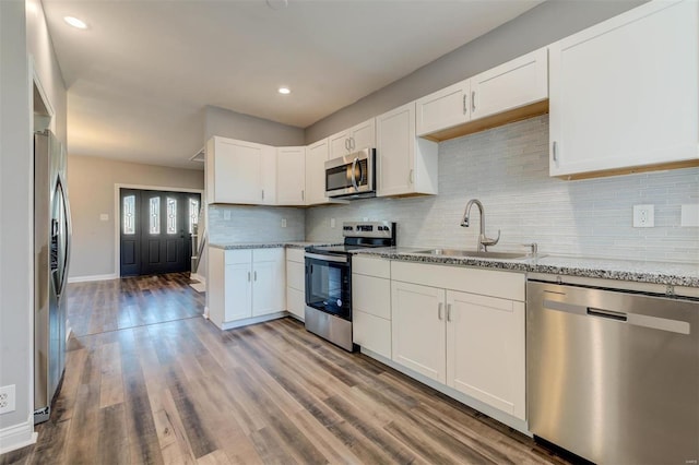 kitchen with appliances with stainless steel finishes and white cabinets