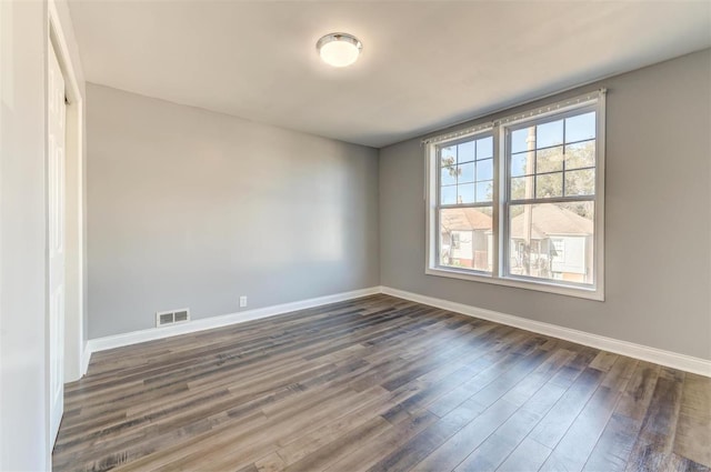 unfurnished room with dark hardwood / wood-style floors