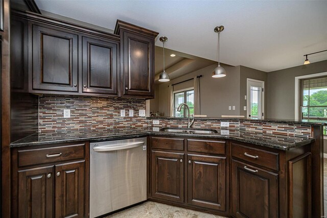 kitchen featuring kitchen peninsula, stainless steel dishwasher, backsplash, and light tile patterned flooring