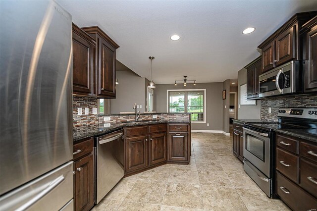 kitchen featuring sink, tasteful backsplash, light tile patterned floors, and stainless steel appliances