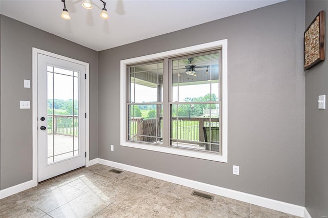 doorway to outside with ceiling fan, light tile patterned floors, and rail lighting