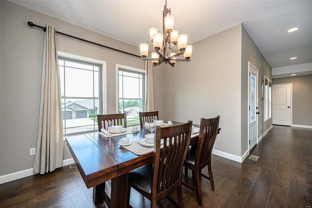 dining room featuring dark hardwood / wood-style floors and a notable chandelier