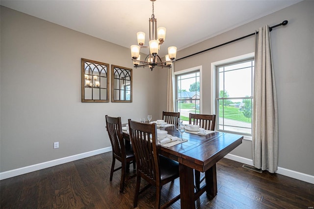 dining room featuring an inviting chandelier and dark hardwood / wood-style floors