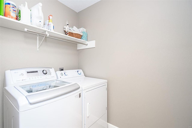 washroom featuring washer and clothes dryer