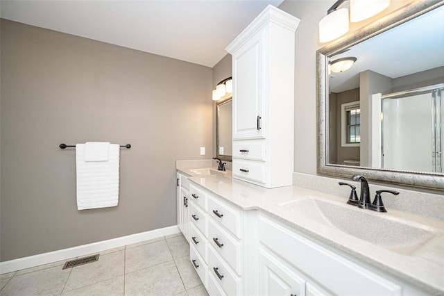 bathroom featuring tile patterned flooring and double vanity