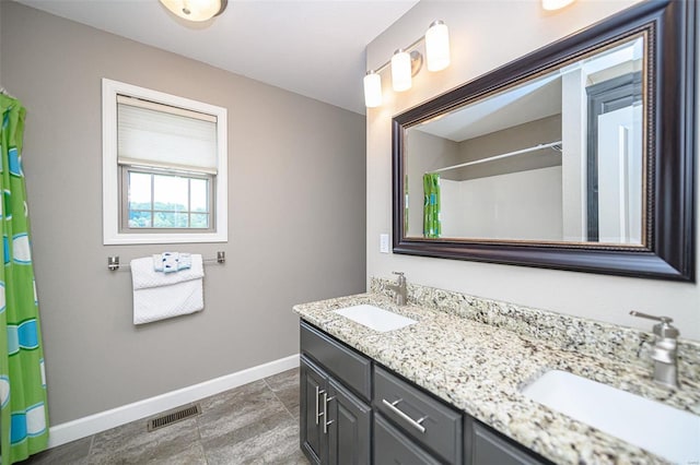 bathroom with double vanity and tile patterned floors