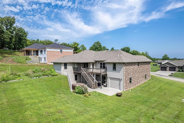 back of house with a garage, a wooden deck, and a lawn