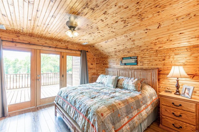 bedroom featuring wood ceiling, vaulted ceiling, french doors, access to exterior, and hardwood / wood-style flooring