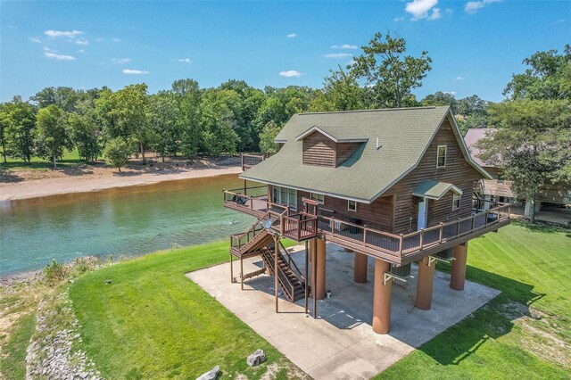 exterior space with a yard and a deck with water view