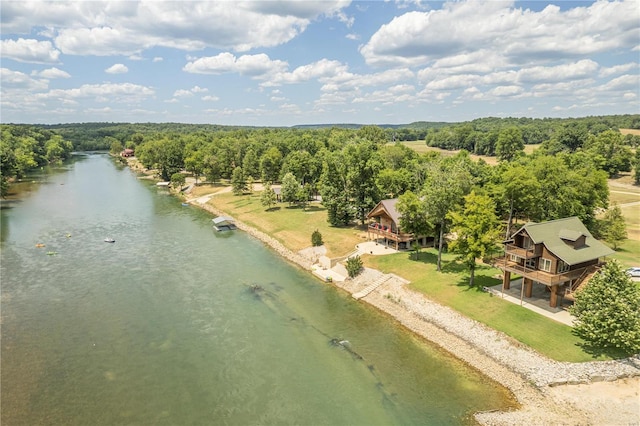 aerial view with a water view and a wooded view