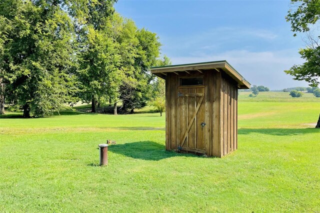 view of outbuilding with a yard