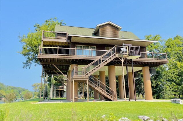 back of house with a deck and a yard