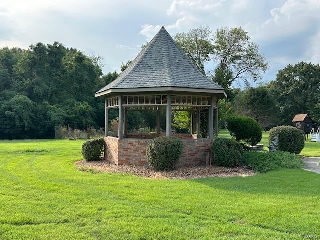 view of property's community featuring a lawn and a gazebo