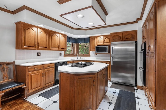 kitchen with crown molding, appliances with stainless steel finishes, a center island, and sink