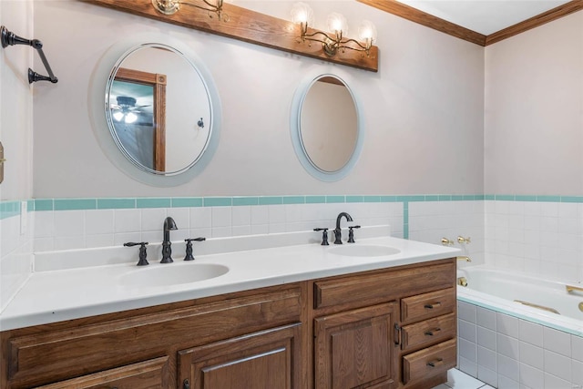 bathroom featuring crown molding, vanity, and tiled tub