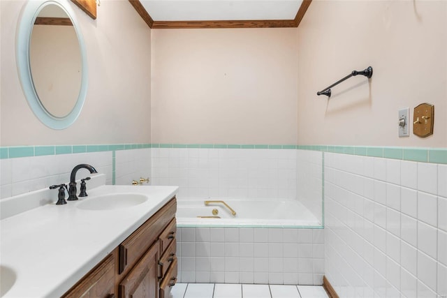 bathroom featuring tiled tub, tile patterned flooring, crown molding, vanity, and tile walls