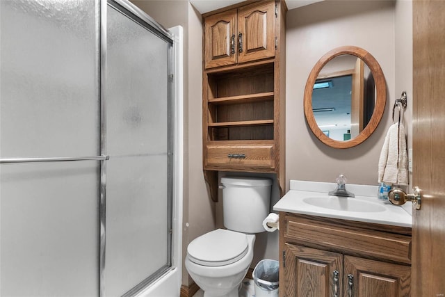 bathroom featuring vanity, toilet, and walk in shower