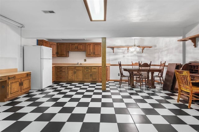 kitchen with white refrigerator and sink