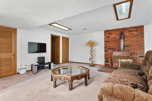 living room with a wood stove and carpet