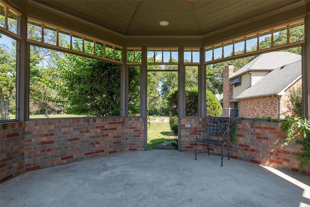 unfurnished sunroom featuring a wealth of natural light and wood ceiling