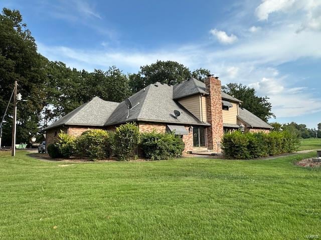 view of side of home featuring a lawn