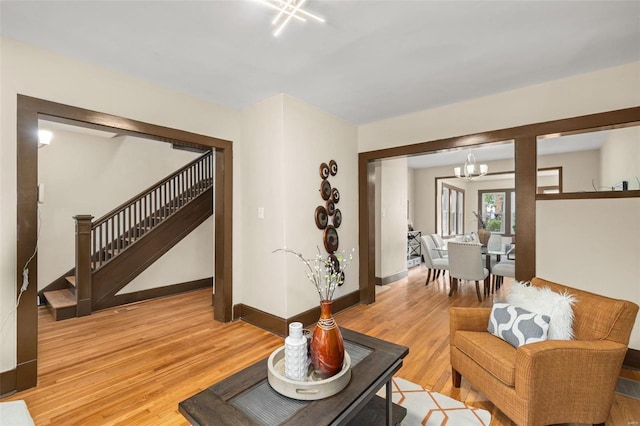 living room featuring light hardwood / wood-style flooring and a notable chandelier