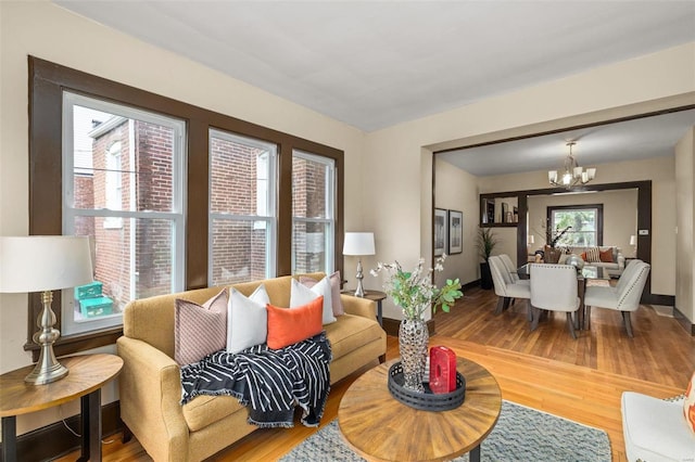 living room featuring light hardwood / wood-style floors and an inviting chandelier