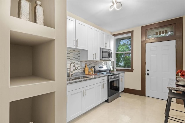 kitchen featuring sink, white cabinetry, appliances with stainless steel finishes, and light tile patterned floors