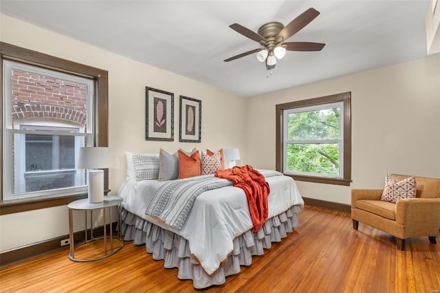 bedroom featuring hardwood / wood-style flooring and ceiling fan