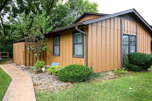 view of property exterior with a lawn