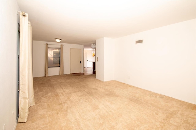 empty room featuring light colored carpet