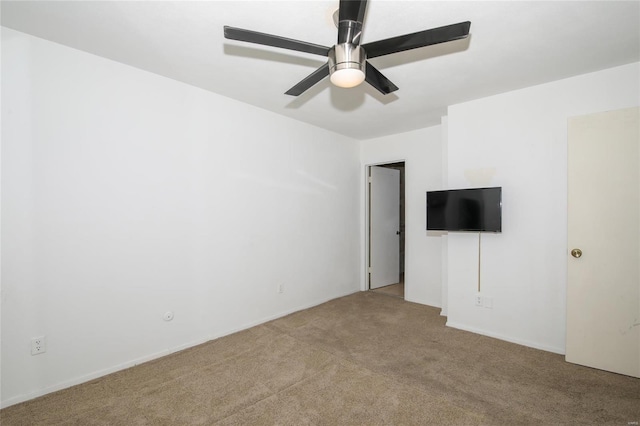 spare room featuring ceiling fan and light colored carpet