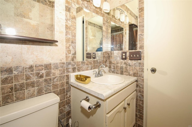 bathroom featuring backsplash, vanity, tile walls, and toilet